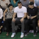 New England Patriots tight end Rob Gronkowski, center, watches the second half of Game 2 of the NBA basketball Eastern Conference finals between the Boston Celtics and the Cleveland Cavaliers, Friday, May 19, 2017, in Boston. (AP Photo/Elise Amendola)