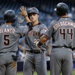 Arizona Diamondbacks' Gregor Blanco, left, and Paul Goldschmidt, right, congratulate Jake Lamb at the plate for Lamb's three-run home run against the San Diego Padres during the first inning of a baseball game in San Diego, Friday, May 19, 2017. (AP Photo/Alex Gallardo)