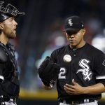 Chicago White Sox pitcher Jose Quintana, right, tosses the ball in the air as Quintana and catcher Kevan Smith, left, wait for manager Rick Renteria to change pitchers during the fifth inning of a baseball game against the Arizona Diamondbacks, Wednesday, May 24, 2017, in Phoenix. (AP Photo/Ross D. Franklin)