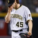 Pittsburgh Pirates pitcher Gerrit Cole wipes his face after giving up an RBI double to Arizona Diamondbacks' Jake Lamb during the third inning of a baseball game Thursday, May 11, 2017, in Phoenix. (AP Photo/Ross D. Franklin)