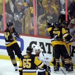 Pittsburgh Penguins' Brian Dumoulin (8) and Carter Rowney (37) celebrate with Nick Bonino after Bonino's goal against the Nashville Predators during the first period in Game 1 of the NHL hockey Stanley Cup Final, Monday, May 29, 2017, in Pittsburgh. (AP Photo/Gene J. Puskar)