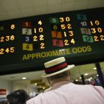 A man studies the tote board ahead of the running of the Preakness Stakes horse race at Pimlico race course, Saturday, May 20, 2017, in Baltimore. The 142nd Preakness Stakes horse race runs Saturday. (AP Photo/Patrick Semansky)