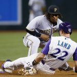 Arizona Diamondbacks' Jake Lamb (22) slides safely into second base with an RBI double as Pittsburgh Pirates' Gift Ngoepe applies a late tag during the third inning of a baseball game Thursday, May 11, 2017, in Phoenix. (AP Photo/Ross D. Franklin)