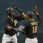 Pittsburgh Pirates' Gregory Polanco, left, celebrates his run-scoring double against the Arizona Diamondbacks with first base coach Kimera Bartee (18) during the first inning of a baseball game Friday, May 12, 2017, in Phoenix. (AP Photo/Ross D. Franklin)