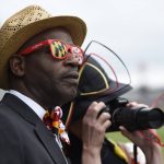 William Brown, of Spencerville, Md., watches the third race at the track ahead of the running of the Preakness Stakes horse race at Pimlico race course, Saturday, May 20, 2017, in Baltimore. The 142nd Preakness Stakes horse race runs Saturday. (AP Photo/Mike Stewart)