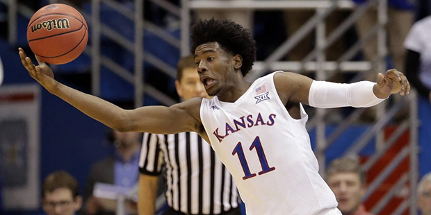 Kansas' Josh Jackson chases a loose ball during the first half of an NCAA college basketball game a...