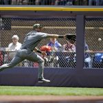 Arizona Diamondbacks' David Peralta chases down a triple by Milwaukee Brewers' Keon Broxton during the first inning of a baseball game Sunday, May 28, 2017, in Milwaukee. (AP Photo/Jeffrey Phelps)