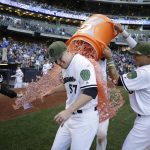 Milwaukee Brewers starting pitcher Chase Anderson (57) is doused by Orlando Arcia, right, at the end of a baseball game against the Arizona Diamondbacks, Saturday, May 27, 2017, in Milwaukee. Anderson did not allow a hit to the Diamondbacks until the eighth inning. (AP Photo/Jeffrey Phelps)