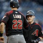 Arizona Diamondbacks' Jake Lamb, left, waits at the plate to congratulate Chris Herrmann for Herrmann's hitting a two-run home run against the San Diego Padres during the first inning of a baseball game in San Diego, Saturday, May 20, 2017. (AP Photo/Alex Gallardo)