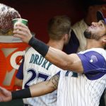 Arizona Diamondbacks' David Peralta tosses a cup of water into the air from the dugout prior to the team's baseball game against the Pittsburgh Pirates on Thursday, May 11, 2017, in Phoenix. (AP Photo/Ross D. Franklin)