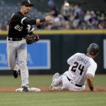 Chicago White Sox Tyler Saladino (20) forces out Arizona Diamondbacks' Yasmany Tomas (24) as he turns a double play on Brandon Drury during the first inning of a baseball game, Tuesday, May 23, 2017, in Phoenix. (AP Photo/Matt York)
