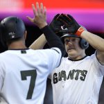 San Francisco Giants' Nick Hundley, right, celebrates with Aaron Hill (7) after hitting a two-run home run off Atlanta Braves' Mike Foltynewicz in the second inning of a baseball game Saturday, May 27, 2017, in San Francisco. (AP Photo/Ben Margot)