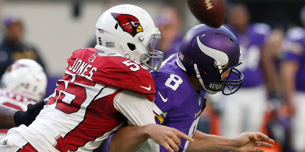 Arizona Cardinals outside linebacker Chandler Jones, left, hits Minnesota Vikings quarterback Sam B...