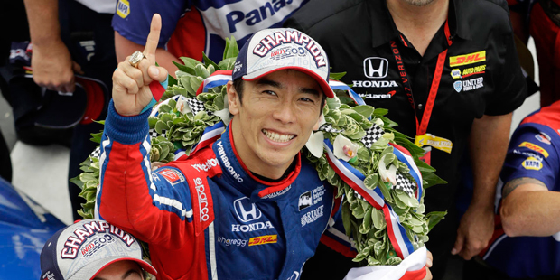 Takuma Sato, center, of Japan, celebrates after winning the Indianapolis 500 auto race at Indianapo...