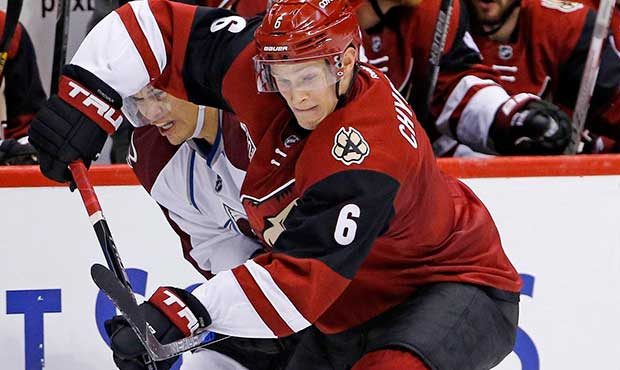 Arizona Coyotes defenseman Jakob Chychrun (6) keeps the puck away from Colorado Avalanche right win...