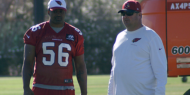 Linebacker Karlos Dansby chats with assistant coach Freddie Kitchens during Arizona Cardinals OTAs ...