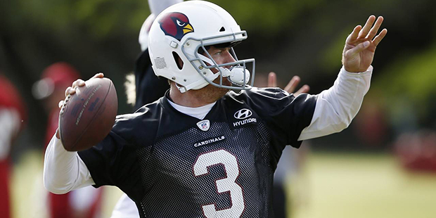 Arizona Cardinals quarterback Carson Palmer throws the football as quarterbacks run drills during a...
