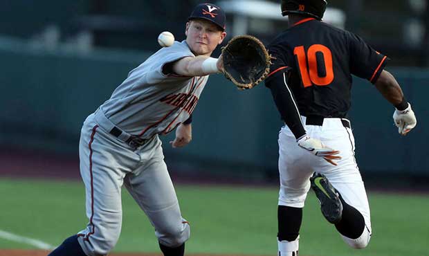 Virginia Tech's Rahiem Cooper (10) is safe at first base past as Virginia's Pavin Smith waits for t...