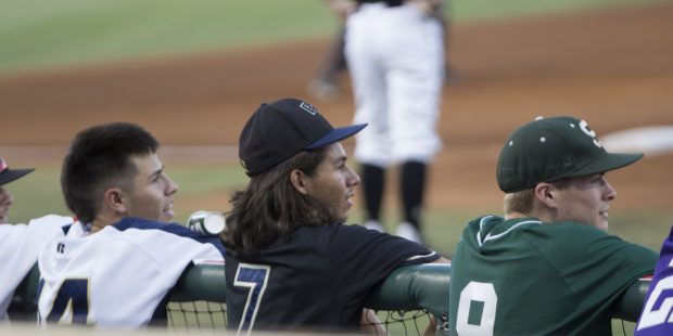 Adrain Salazar (middle) watches from the dugout at Goodyear Ballpark during the AZ Baseball Coaches...