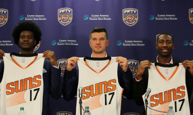 Josh Jackson (left), Alec Peters (center) and Davon Reed (right) hold up Suns jerseys with the numb...