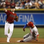 Arizona Diamondbacks' Brandon Drury, left, throws to first base to complete a double play after forcing out Philadelphia Phillies' Aaron Altherr, right, at second base during the fourth inning of a baseball game Sunday, June 25, 2017, in Phoenix. (AP Photo/Ross D. Franklin)
