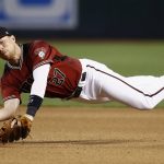 Arizona Diamondbacks' Brandon Drury makes a one-handed grab of the baseball and throw to first base during the seventh inning of a baseball game but is unable to get Philadelphia Phillies' Odubel Herrera Sunday, June 25, 2017, in Phoenix. The Diamondbacks defeated the Phillies 2-1. (AP Photo/Ross D. Franklin)