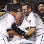 Arizona Diamondbacks' Chris Herrmann, middle, celebrates his walk off single against the St. Louis Cardinals with Jeff Mathis (2) and Daniel Descalso, right, during the 10th inning of a baseball game Tuesday, June 27, 2017, in Phoenix. The Diamondbacks defeated the Cardinals 6-5. (AP Photo/Ross D. Franklin)