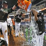 Miami Marlins' Justin Bour, left, and Marcell Ozuna, center rear, pour ice and water onto starting pitcher Edinson Volquez, right, after the Marlins defeated the Arizona Diamondbacks 3-0 in a no-hitter by Volquez during a baseball game, Saturday, June 3, 2017, in Miami. (AP Photo/Wilfredo Lee)