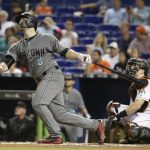 Arizona Diamondbacks' Chris Iannetta (8) watches jos solo home run during the fifth inning of a baseball game against the Miami Marlins, Friday, June 2, 2017, in Miami. At right is Marlins catcher J.T. Realmuto. (AP Photo/Lynne Sladky)