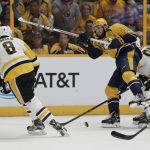 Pittsburgh Penguins defenseman Brian Dumoulin (8) pushes the puck past Nashville Predators center Colton Sissons (10) during the first period in Game 3 of the NHL hockey Stanley Cup Finals Saturday, June 3, 2017, in Nashville, Tenn. (AP Photo/Mark Humphrey)