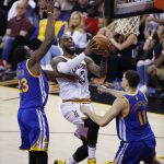 Cleveland Cavaliers forward LeBron James (23) drives on Golden State Warriors forward Draymond Green (23) and Klay Thompson (11) during the first half of Game 4 of basketball's NBA Finals in Cleveland, Friday, June 9, 2017. (AP Photo/Ron Schwane)