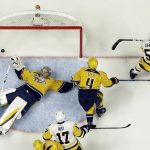 Pittsburgh Penguins center Jake Guentzel, right, celebrates his goal against Nashville Predators goalie Pekka Rinne, of Finland, left, and Ryan Ellis, center, during the first period of Game 3 of the NHL hockey Stanley Cup Finals Saturday, June 3, 2017, in Nashville, Tenn. (AP Photo/Mark Humphrey)
