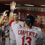St. Louis Cardinals' Matt Carpenter (13) celebrates his run against the Arizona Diamondbacks with Paul DeJong, left, and Tyler Lyons, middle, during the eighth inning of a baseball game Wednesday, June 28, 2017, in Phoenix. The Cardinals defeated the Diamondbacks 4-3. (AP Photo/Ross D. Franklin)