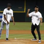 The Phoenix Suns' NBA basketball first-round pick Josh Jackson, left, and Arizona Cardinals 2017 NFL football first-round pick Haason Reddick, right, follow through on their ceremonial first pitch attempts prior to a baseball game between the Arizona Diamondbacks and the Philadelphia Phillies, Friday, June 23, 2017, in Phoenix. (AP Photo/Ross D. Franklin)