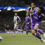 Real Madrid's Marcelo, right, challenges for the ball with Juventus' Dani Alves during the Champions League final soccer match between Juventus and Real Madrid at the Millennium Stadium in Cardiff, Wales, Saturday June 3, 2017. (AP Photo/Kirsty Wigglesworth)