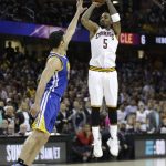 Cleveland Cavaliers guard JR Smith (5) shoots over Golden State Warriors center Zaza Pachulia (27) during the first half of Game 4 of basketball's NBA Finals in Cleveland, Friday, June 9, 2017. (AP Photo/Tony Dejak)