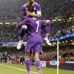 Real Madrid's Cristiano Ronaldo celebrates with Real Madrid's Sergio Ramos, top, after scoring the opening goal during the Champions League final soccer match between Juventus and Real Madrid at the Millennium stadium in Cardiff, Wales Saturday June 3, 2017. (AP Photo/Frank Augstein)