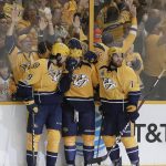 Nashville Predators left wing Filip Forsberg (9), of Sweden, and defenseman Yannick Weber (7), of Switzerland, celebrate with right wing Craig Smith (15) after Smith's goal against the Pittsburgh Penguins during the third period in Game 3 of the NHL hockey Stanley Cup Finals Saturday, June 3, 2017, in Nashville, Tenn. (AP Photo/Mark Humphrey)