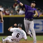 Colorado Rockies' Trevor Story forces out Arizona Diamondbacks' David Peralta (6) but can't throw out Jake Lamb during the fifth inning of a baseball game, Friday, June 30, 2017, in Phoenix. (AP Photo/Matt York)