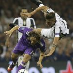 Real Madrid's Luka Modric, left, challenges for the ball with Juventus' Paulo Dybala during the Champions League final soccer match between Juventus and Real Madrid at the Millennium Stadium in Cardiff, Wales, Saturday June 3, 2017. (AP Photo/Tim Ireland)