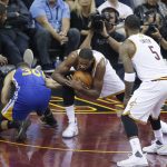Cleveland Cavaliers center Tristan Thompson recovers a loose ball from Golden State Warriors guard Stephen Curry (30) during the first half of Game 4 of basketball's NBA Finals in Cleveland, Friday, June 9, 2017. (AP Photo/Ron Schwane)