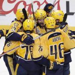 Nashville Predators left wing Filip Forsberg (9), of Sweden, is congratulated after scoring an empty net goal against the Pittsburgh Penguins during the third period in Game 4 of the NHL hockey Stanley Cup Finals Monday, June 5, 2017, in Nashville, Tenn. The Predators won 4-1 to tie the series 2-2. (AP Photo/Mark Humphrey)