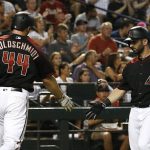 Arizona Diamondbacks' Paul Goldschmidt (44) celebrates with Daniel Descalso, right, after scoring against the Philadelphia Phillies during the fourth inning of a baseball game Saturday, June 24, 2017, in Phoenix. (AP Photo/Ross D. Franklin)