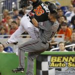 Arizona Diamondbacks' Reymond Fuentes (14) collides with Miami Marlins starting pitcher Edinson Volquez (36) after Volquez tagged first base for the out during the first inning of a baseball game, Saturday, June 3, 2017, in Miami. (AP Photo/Wilfredo Lee)