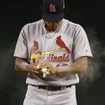 St. Louis Cardinals' Carlos Martinez uses the rosin bag on his arms during the first inning of a baseball game against the Arizona Diamondbacks, Tuesday, June 27, 2017, in Phoenix. (AP Photo/Ross D. Franklin)