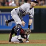 Milwaukee Brewers' Eric Sogard (18) forces out Arizona Diamondbacks' Daniel Descalso (3) as he turns a double play against Paul Goldschmidt during the fourth inning of a baseball game, Saturday, June 10, 2017, in Phoenix. (AP Photo/Matt York)
