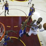 Cleveland Cavaliers guard Kyrie Irving (2) shoots as Golden State Warriors forward Andre Iguodala defends during the first half of Game 4 of basketball's NBA Finals in Cleveland, Friday, June 9, 2017. (Larry W. Smith/Pool Photo via AP)