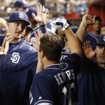 San Diego Padres' Hunter Renfroe, middle, celebrates his home run against the Arizona Diamondbacks with teammates and coaches in the dugout during the fourth inning of a baseball game Tuesday, June 6, 2017, in Phoenix. (AP Photo/Ross D. Franklin)