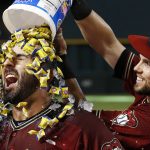 Arizona Diamondbacks' Daniel Descalso, left, celebrates his game-winning walk off single against the Philadelphia Phillies with Chris Owings, right, after a baseball game Sunday, June 25, 2017, in Phoenix. The Diamondbacks defeated the Phillies 2-1. (AP Photo/Ross D. Franklin)