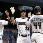 Arizona Diamondbacks' Jake Lamb (22) celebrates his three-run home run against the Milwaukee Brewers with Gregor Blanco (5) and Paul Goldschmidt (44) during the first inning of a baseball game Friday, June 9, 2017, in Phoenix. (AP Photo/Ross D. Franklin)